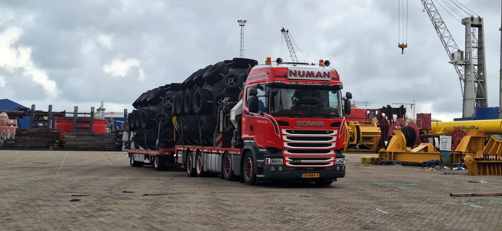 Vrachtwagen Numan Transport met grote boeien op de trailer.